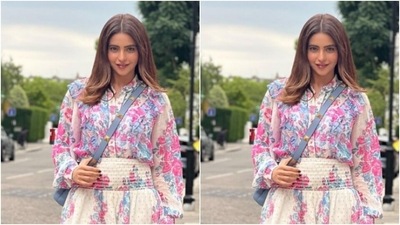 Aamna decked up in a white shirt that came with collars and full sleeves. The shirt featured intricate prints in shades of blue and pink in floral patterns. (Instagram/@aamnasharifofficial)