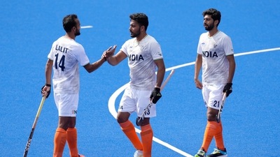 Harmanpreet Singh of India, centre, celebrates with Lalit Kumar Upadhyay of India, left, and Shamsher Singh of India after they win their hockey match (AP)