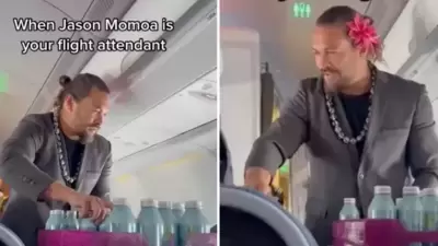 Jason Momoa handing out water bottles aboard a Hawaiian Airlines flight on Tuesday. Jason Momoa handing out water bottles aboard a Hawaiian Airlines flight on Tuesday.