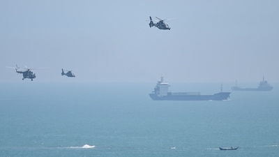 Chinese military helicopters fly past Pingtan island, one of mainland China's closest point from Taiwan, in Fujian province on Thursday. (AFP)