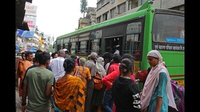 Commuters boarding at PMPML bus on Shivaji road on Thursday. (Ravindra Joshi/HT PHOTO)