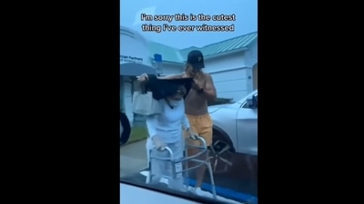 The image, taken from the viral video, shows the man protecting the elderly lady from the rain using his shirt. (Instagram/@goodnews_movement) The image, taken from the viral video, shows the man protecting the elderly lady from the rain using his shirt. (Instagram/@goodnews_movement)
