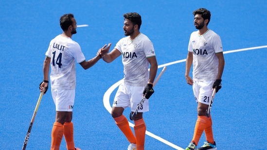 Harmanpreet Singh of India, centre, celebrates with Lalit Kumar Upadhyay of India, left, and Shamsher Singh of India after they win their hockey match(AP)