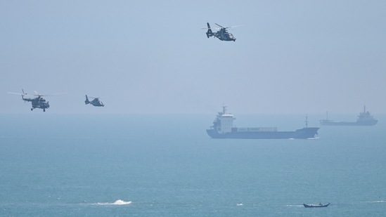 Chinese military helicopters fly past Pingtan island, one of mainland China's closest point from Taiwan, in Fujian province on Thursday. (AFP)