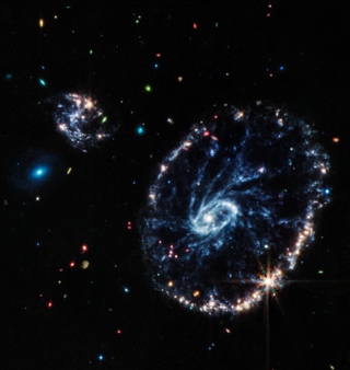 Webb’s Mid-Infrared Instrument (MIRI) shows a group of galaxies, including a large distorted ring-shaped Cartwheel galaxy.(Credits: NASA, ESA, CSA, STScI, Webb ERO Production Team)