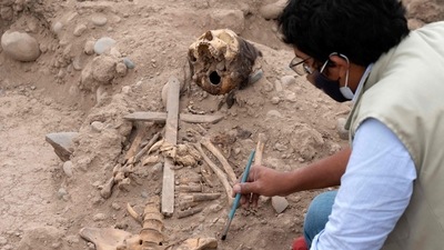 A Peruvian archaeologist works at a 1,000-year-old pre-Hispanic sanctuary located inside the capital's main zoo, where three colonial-era burials were found, in Lima, on August 4, 2022. (AFP)