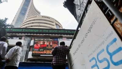 People watch the television screen installed outside Bombay Stock Exchange. (REUTERS)