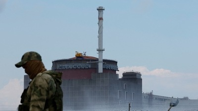 A serviceman with a Russian flag on his uniform stands guard near the Zaporizhzhia Nuclear Power Plant in the course of Ukraine-Russia conflict outside the Russian-controlled city of Enerhodar in the Zaporizhzhia region. (REUTERS)