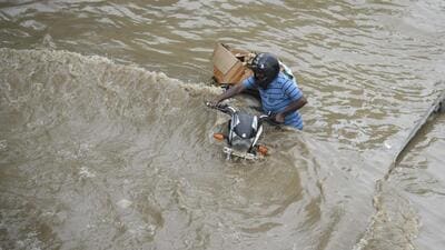 Gurugram, India-August 05: A commuter pushes his bike through a waterlogged street due to heavy rains on the National Highway-48 service road near the Narsinghpur village foot-over-bridge, in Gurugram, India, on Friday, 05 August 2022. (Photo by Parveen Kumar/Hindustan Times) Gurugram, India-August 05: A commuter pushes his bike through a waterlogged street due to heavy rains on the National Highway-48 service road near the Narsinghpur village foot-over-bridge, in Gurugram, India, on Friday, 05 August 2022. (Photo by Parveen Kumar/Hindustan Times)