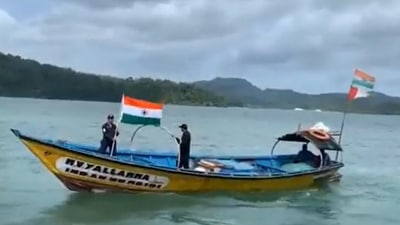 A video shared by the Coast Guard showed officials furling the national flag from the vessel floating in the sea. (Videograb: ANI)