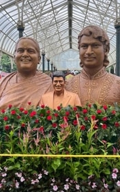 Statues of Dr Rajkumar, his wife Parvathamma and son Puneeth Rajkumar at Lalbagh this year. (Image credit: @AbDeVil68009622/Twitter) Statues of Dr Rajkumar, his wife Parvathamma and son Puneeth Rajkumar at Lalbagh this year. (Image credit: @AbDeVil68009622/Twitter)