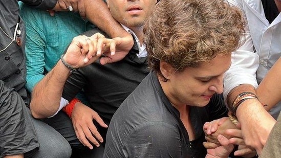 Congress General Secretary Priyanka Gandhi Vadra jumps over a police barricade placed near AICC during party protest against price rise & unemployment in Delhi(HT Photo )