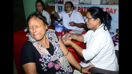 Guwahati, Aug 05 (ANI): A healthcare worker administers a booster dose of COVID-19 vaccine to a beneficiary, in Guwahati on Friday. (ANI Photo) (Rupjyoti Sarmah)