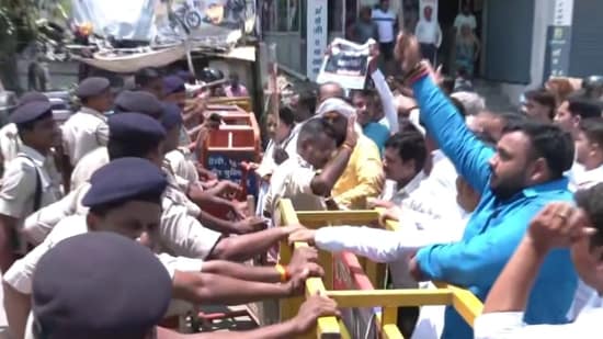 In Bihar's Patna, police were seen holding onto the barricades to stop protestors from heading forth as Congress members took out a protest march over inflation and unemployment.(ANI)