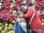Bengaluru: Tourists click selfies during their visit to the annual Independence Day flower show, at Lalbagh Botanical Garden in Bengaluru, Friday, Aug. 5, 2022. (PTI Photo/Shailendra Bhojak)(PTI08_05_2022_000264A)(PTI)