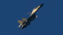 A Chinese J-11 military fighter jet flies above the Taiwan Strait near Pingtan.