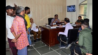 Members of the panel formed by MC House verifying details of the civic body’s contractual employees at the Zone-D office in Ludhiana on Saturday. (Harvinder Singh/HT)