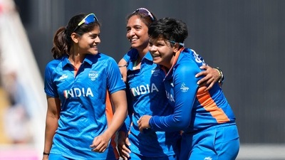 India's captain Harmanpreet Kaur, center, celebrates with teammates Radha Yadav, left, and Shafali Verma after their win in the women's cricket T20 semifinal match against England at Edgbaston at the Commonwealth Games in Birmingham (AP)