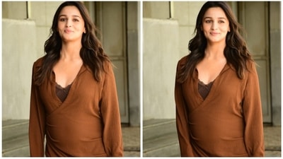 Alia Bhatt wore a lace bralette underneath the solid brown dress. She left her hair open and wore minimal makeup to flaunt her pregnancy glow. (HT Photo/Varinder Chawla)