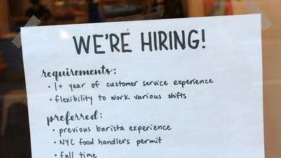 A hiring sign is seen in a cafe as the US Labor Department released its July employment report, in Manhattan, New York City. (REUTERS)