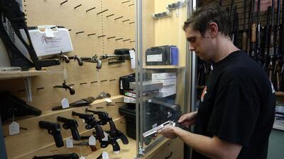 A salesman takes a Ruger GP100 Magnum 357 handgun from the display case at That Hunting Store in Ottawa, Canada. (AFP) A salesman takes a Ruger GP100 Magnum 357 handgun from the display case at That Hunting Store in Ottawa, Canada. (AFP)