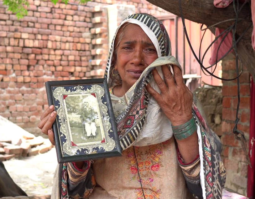 TEARS OF JOY: Sakina Bibi of Noorpur, Pakistan, holding the picture of her brother, Gurmail Singh Grewal, which her mother once received from India. (Photo sourced from Punjabi Lehar) TEARS OF JOY: Sakina Bibi of Noorpur, Pakistan, holding the picture of her brother, Gurmail Singh Grewal, which her mother once received from India. (Photo sourced from Punjabi Lehar)