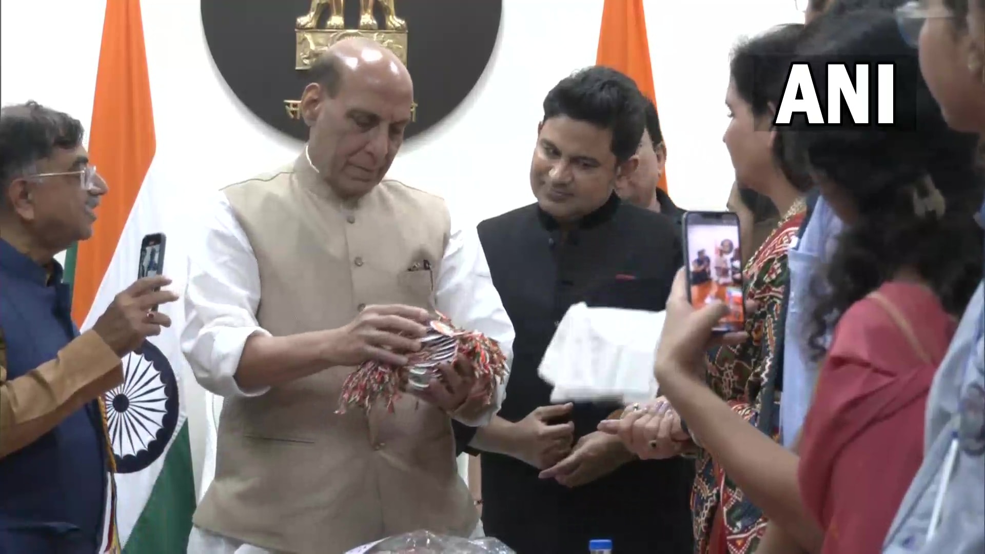 Rajnath Singh takes a look at the rakhis made by school students. (ANI) Rajnath Singh takes a look at the rakhis made by school students. (ANI)