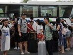 People get off a coach at an entrance of Atlantis Sanya resort in Sanya, Hainan province, in November last year. (REUTERS)(HT_PRINT)