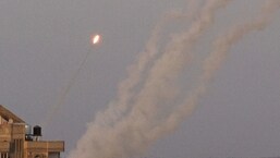 A volley of rockets is launched from Gaza City towards Israel on Sunday.