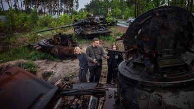 Local residents examine destroyed Russian tanks outside Kyiv. (AFP file) Local residents examine destroyed Russian tanks outside Kyiv. (AFP file)