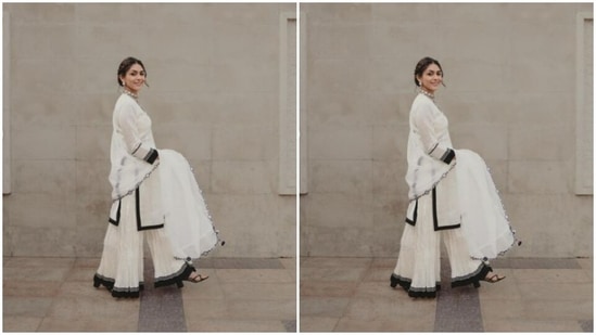 Mrunal decked up in a white cotton kurta featuring a V-neckline and full sleeves. The kurta featured borders in black at the midriff and at the cuffs.(Instagram/@mrunalthakur)