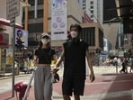 A couple wearing face masks walk along a street in Mongkok, a shopping district of Hong Kong. (AP)