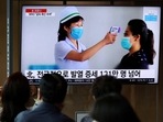 FILE PHOTO: People watch a TV broadcasting a news report on the coronavirus disease (COVID-19) outbreak in North Korea, at a railway station in Seoul, South Korea.