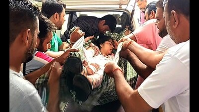 An injured child being helped out of the school van which met with an accident on Monday. (HT Photo) An injured child being helped out of the school van which met with an accident on Monday. (HT Photo)