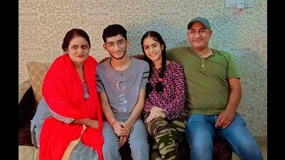 Ludhiana’s Aryaman Angurman, who secured AIR 197 in JEE Main, celebrating with his family on Monday.