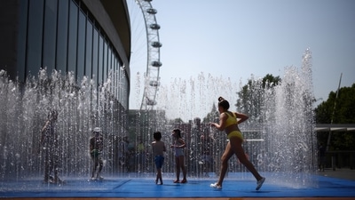 Children cool off in a water fountain during a heatwave, in London, Britain. (File) (REUTERS)