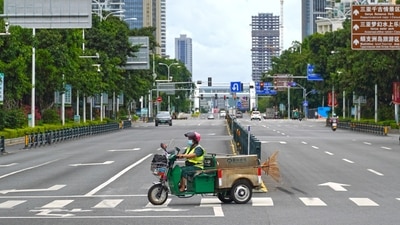 A sanitation worker drives past an intersection amid lockdown measures to curb the coronavirus disease (Covid-19) outbreak in Sanya, Hainan province, China &nbsp; (via REUTERS)