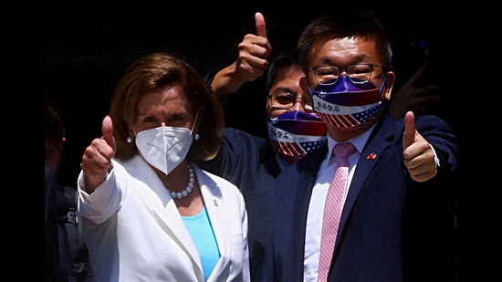 US House of Representatives Speaker Nancy Pelosi gestures next to Legislative Yuan Vice President Tsai Chi-chang as she leaves the parliament in Taipei, Taiwan, August 3, 2022 (REUTERS)