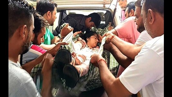 An injured child being helped out of the school van which met with an accident on Monday. (HT Photo)