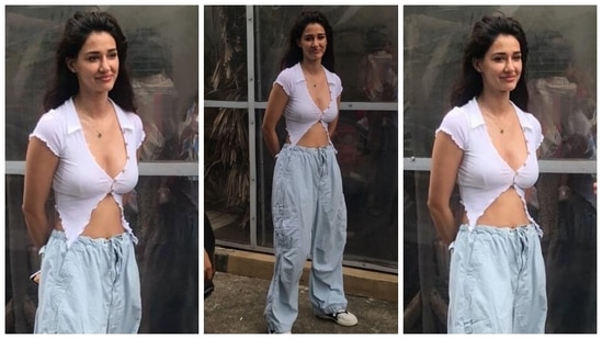 Disha slipped into a white crop top for the lunch outing with her director. It comes with a plunging collared neckline flaunting the star's decolletage, faux button-up details, half sleeves, asymmetric cropped hem, and a midriff-baring front that showed off Disha's washboard abs.(HT Photo/Varinder Chawla)