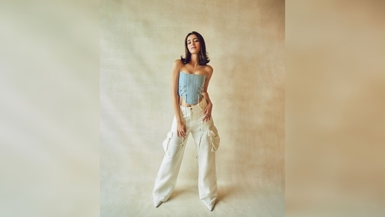 Ananya Panday's corset top features lace detailing. She styled her casual yet trendy outfit with white pointed ankle boots.(Instagram/@spacemuffic27)