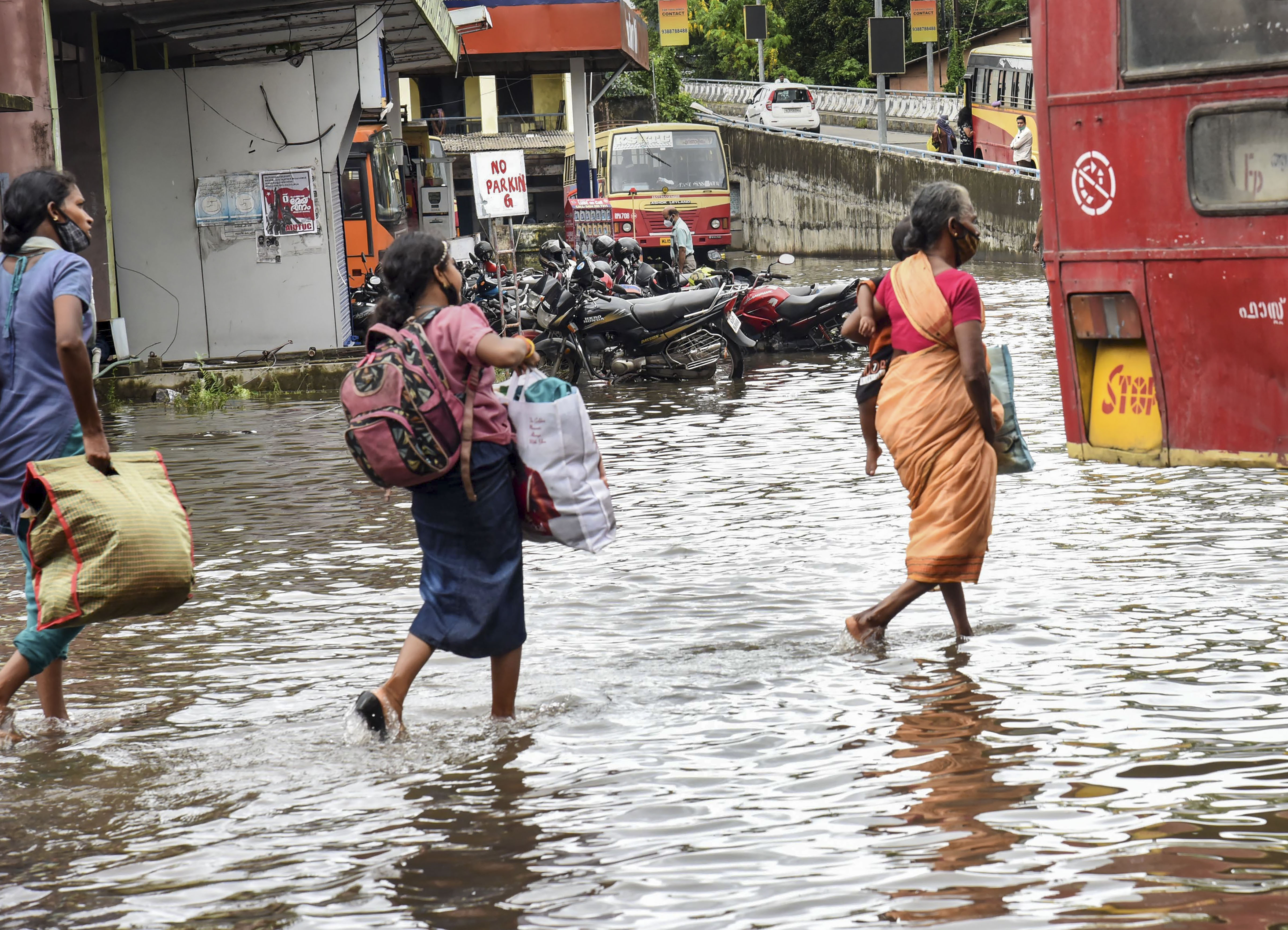 Commuters wade through a waterlogged road after heavy rain. (Representative image) (PTI) Commuters wade through a waterlogged road after heavy rain. (Representative image) (PTI)