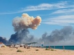 Rising smoke can be seen from the beach at Saky after explosions were heard from the direction of a Russian military airbase near Novofedorivka, Crimea, Tuesday August 9, 2022. (UGC via AP) Rising smoke can be seen from the beach at Saky after explosions were heard from the direction of a Russian military airbase near Novofedorivka, Crimea, Tuesday August 9, 2022. (UGC via AP)