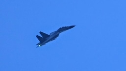 A Chinese military jet flies over Pingtan island, one of mainland China's closest points to Taiwan, in Fujian province on Saturday. 