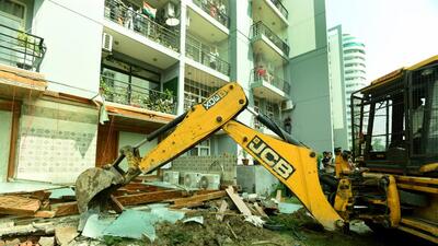 The Noida authority on Monday demolished illegal structures raised by local politician Shrikant Tyagi at the Grand Omaxe Society in Sector 93B. (Sunil Ghosh/ HT) The Noida authority on Monday demolished illegal structures raised by local politician Shrikant Tyagi at the Grand Omaxe Society in Sector 93B. (Sunil Ghosh/ HT)