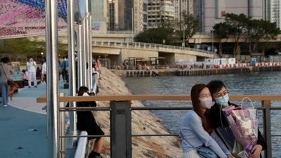 Medical experts say it's okay to support your partner if they have COVID, but it's best not to 'hang out', even if you just recovered from an infection (Lam Yik/REUTERS) Medical experts say it's okay to support your partner if they have COVID, but it's best not to 'hang out', even if you just recovered from an infection (Lam Yik/REUTERS)