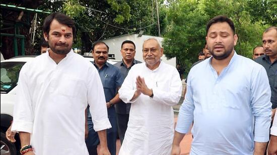 JD (U) leader Nitish Kumar with RJD leaders Tejashwi Yadav and Tej Pratap Yadav at former Bihar CM Rabri Devi's residence, in Patna on Tuesday. (ANI)