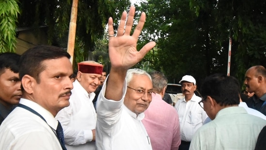 JDU leader Nitish Kumar waves to his supporters after meeting Bihar governor Phagu Chauhan to form a new government in Patna, Bihar,&nbsp;