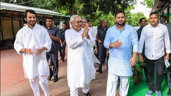 Janata Dal (United) leader Nitish Kumar with Rashtriya Janata Dal leaders Tejashwi Yadav and Tej Pratap in Patna on Tuesday. (PTI)