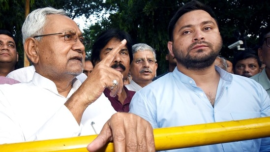 JD(U) leader Nitish Kumar speaks to the media after meeting Bihar governor Phagu Chauhan, as RJD's Tejashwi Yadav looks on, in Patna on Tuesday.&nbsp;(ANI)